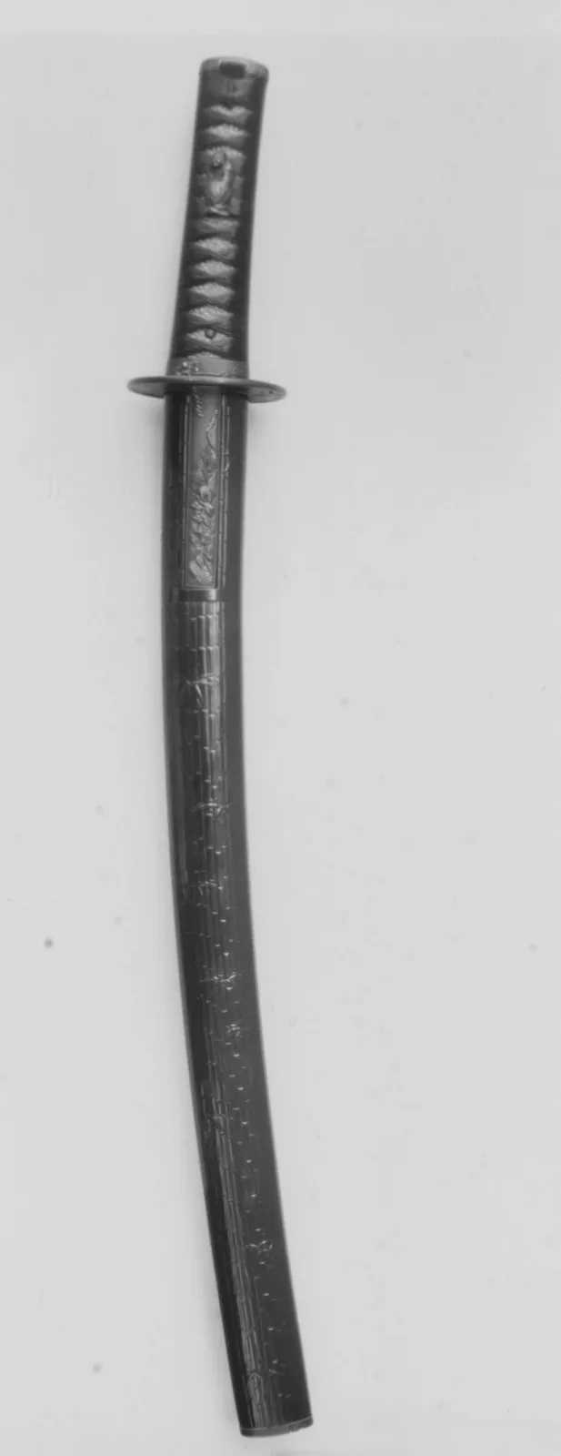 Wakizashi montado por completo, con vaina lacada, empuñadura envuelta y guarda, mostrando su curvatura de un extremo a otro.